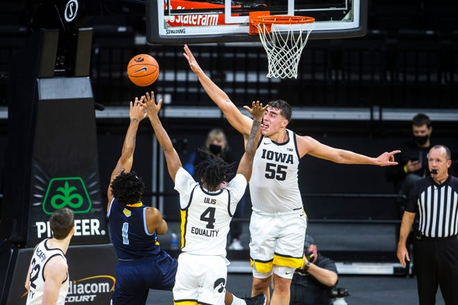 Iowa center Luka Garza (55) defends a shot with Iowa guard Ahron Ulis (4) against Southern University's Ahsante Shivers (1) during a NCAA non-conference men's basketball game, Friday, Nov. 27, 2020, at Carver-Hawkeye Arena in Iowa City, Iowa.