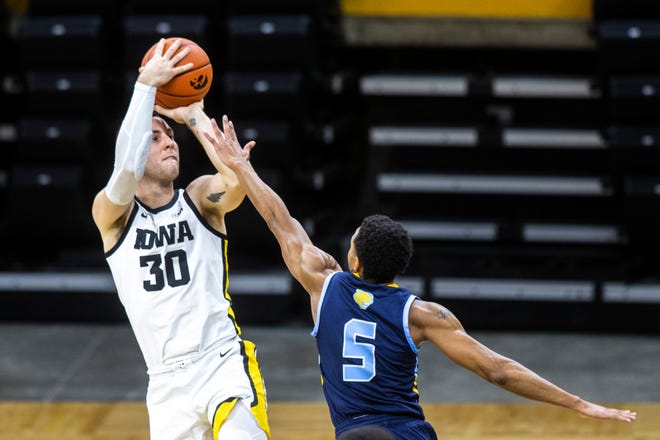 Iowa's Connor McCaffery (30) makes a basket as Southern University's Jayden Saddler (5) defends during a NCAA non-conference men's basketball game, Friday, Nov. 27, 2020, at Carver-Hawkeye Arena in Iowa City, Iowa.