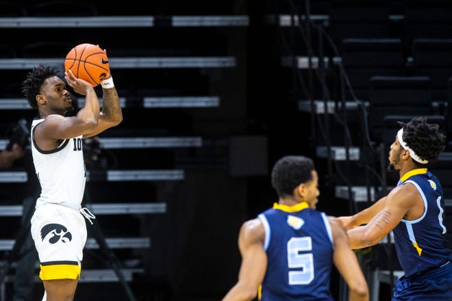Iowa guard Joe Toussaint (1) shoots a basket as Southern University's Ahsante Shivers, right, and Jayden Saddler defend during a NCAA non-conference men's basketball game, Friday, Nov. 27, 2020, at Carver-Hawkeye Arena in Iowa City, Iowa.