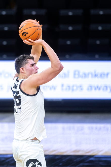 Iowa center Luka Garza (55) makes a 3-point basket during a NCAA non-conference men's basketball game, Friday, Nov. 27, 2020, at Carver-Hawkeye Arena in Iowa City, Iowa.