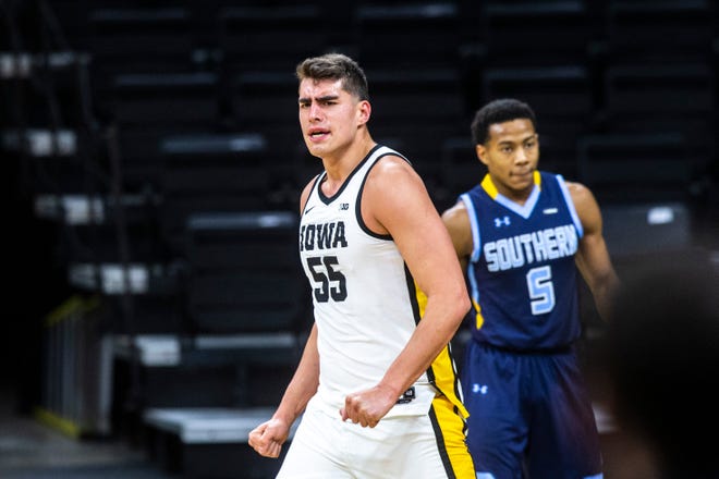 Iowa center Luka Garza (55) reacts after getting fouled during a NCAA non-conference men's basketball game as Southern University's Jayden Saddler (5) looks on, Friday, Nov. 27, 2020, at Carver-Hawkeye Arena in Iowa City, Iowa.