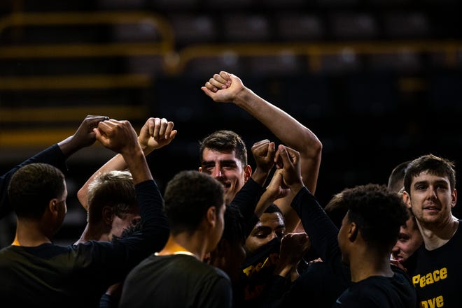 Iowa center Luka Garza (55) huddles up with teammates during introductions before a NCAA non-conference men's basketball game, Friday, Nov. 27, 2020, at Carver-Hawkeye Arena in Iowa City, Iowa.