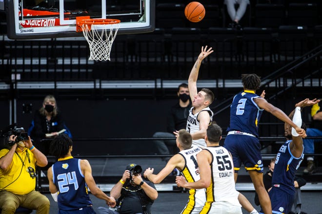 Iowa guard CJ Fredrick (5) makes a layup during a NCAA non-conference men's basketball game against Southern University, Friday, Nov. 27, 2020, at Carver-Hawkeye Arena in Iowa City, Iowa.