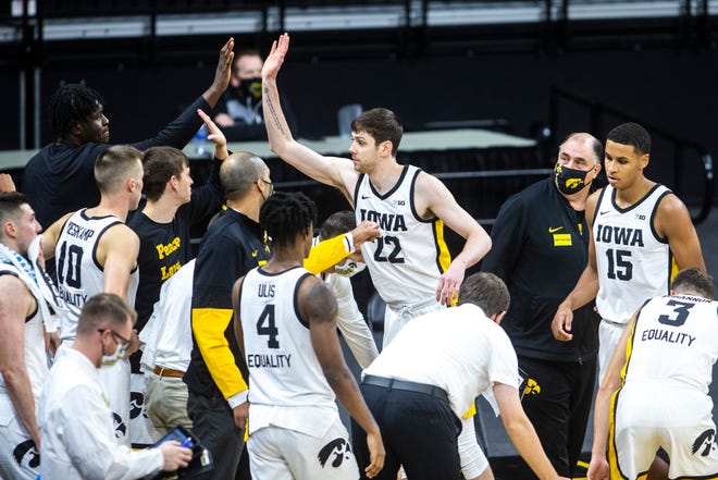 Iowa forward Patrick McCaffery (22) gets a high-five from teammate Josh Ogundele heading into a timeout during a NCAA non-conference men's basketball game, Friday, Nov. 27, 2020, at Carver-Hawkeye Arena in Iowa City, Iowa.