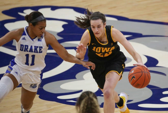 Iowa guard Caitlin Clark dribbles the ball down the court as she is pressed by Drake's Kierra Collier in the first quarter at the Knapp Center in Des Moines on Wednesday, Dec. 2, 2020.
