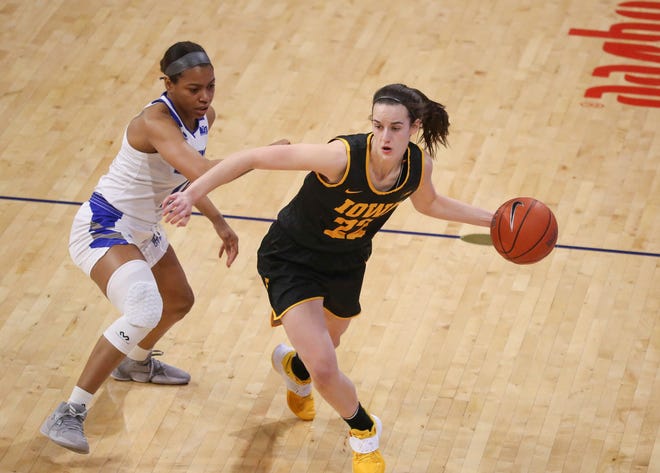 Iowa guard Caitlin Clark dribbles the ball down the court as she is pressed by Drake's Kierra Collier in the first quarter at the Knapp Center in Des Moines on Wednesday, Dec. 2, 2020.