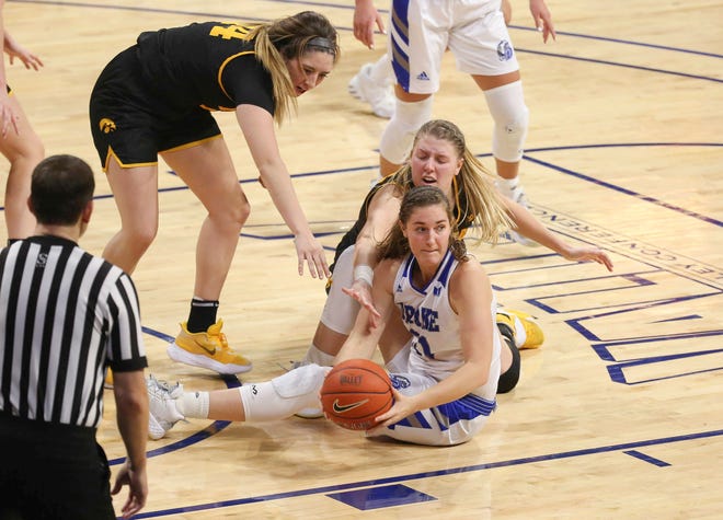 Drake's Allie Wooldridge secures a loose ball in the fourth quarter against Iowa at the Knapp Center in Des Moines on Wednesday, Dec. 2, 2020.