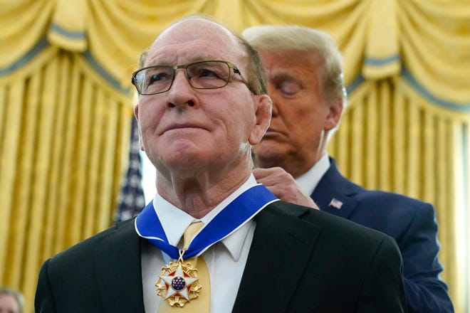 President Donald Trump awards the Presidential Medal of Freedom, the highest civilian honor, to Olympic gold medalist and former University of Iowa wrestling coach Dan Gable in the Oval Office of the White House, Monday, Dec. 7, 2020, in Washington.