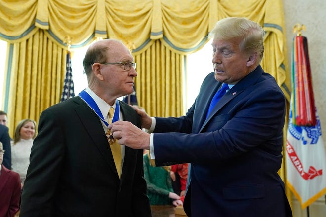 President Donald Trump awards the Presidential Medal of Freedom, the highest civilian honor, to Olympic gold medalist and former University of Iowa wrestling coach Dan Gable in the Oval Office of the White House, Monday, Dec. 7, 2020, in Washington.