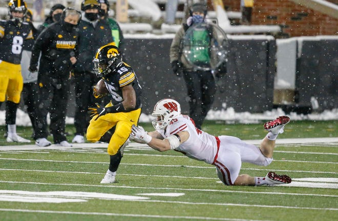 Iowa sophomore running back Tyler Goodson slips out of a Wisconsin tackle for a first down in the third quarter on Saturday, Dec. 12, 2020, at Kinnick Stadium in Iowa City, Iowa.