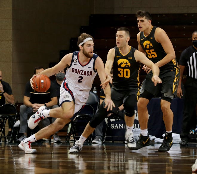 SIOUX FALLS, SD - DECEMBER 19: Drew Timme #2 of the Gonzaga Bulldogs drives to then asket against Connor McCaffery #30 and Luka Garza #55 of the Iowa Hawkeyes during their game at the Sanford Pentagon on December 17, 2020 in Sioux Falls, South Dakota. (Photo by Dave Eggen/Inertia)
