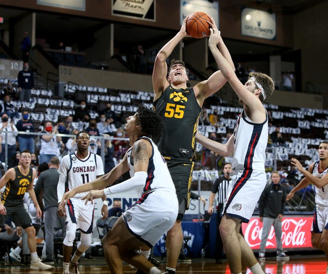 SIOUX FALLS, SD - DECEMBER 19: Luka Garza #55 of the Iowa Hawkeyes takes the ball to the basket against Corey Kispert #24 of the Gonzaga Bulldogs during their game at the Sanford Pentagon on December 17, 2020 in Sioux Falls, South Dakota. (Photo by Dave Eggen/Inertia)