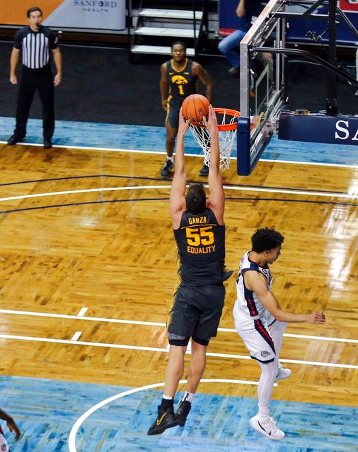 Iowa center Luka Garza (55) dunks the basketball over a Gonzaga defender during the first half of an NCAA college basketball game Saturday, Dec. 19, 2020 in SIoux Falls, S.D. (AP Photo/Josh Jurgens)