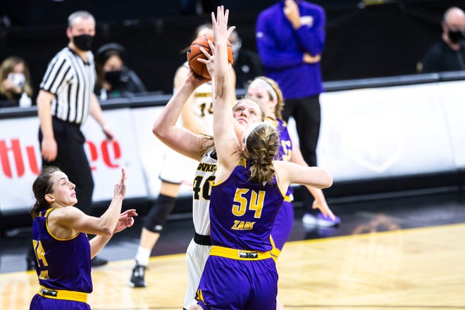 Iowa center Sharon Goodman gets fouled Western Illinois forward Evan Zars (54) while attempting a basket during a NCAA non-conference women's basketball game, Tuesday, Dec. 22, 2020, at Carver-Hawkeye Arena in Iowa City, Iowa.