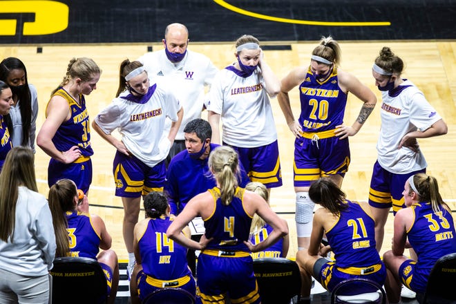 Western Illinois head coach JD Gravina talks with players in a timeout during a NCAA non-conference women's basketball game, Tuesday, Dec. 22, 2020, at Carver-Hawkeye Arena in Iowa City, Iowa.