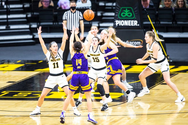 Iowa guard Megan Meyer (11) defends as Western Illinois' Elizabeth Lutz (14) passes during a NCAA non-conference women's basketball game, Tuesday, Dec. 22, 2020, at Carver-Hawkeye Arena in Iowa City, Iowa.