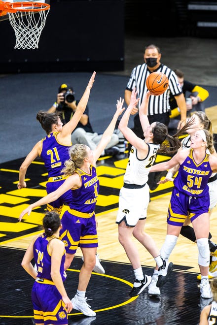 Iowa guard Caitlin Clark (22) gets fouled by Western Illinois guard Grace Gilmore (21) while driving to the basket during a NCAA non-conference women's basketball game, Tuesday, Dec. 22, 2020, at Carver-Hawkeye Arena in Iowa City, Iowa.