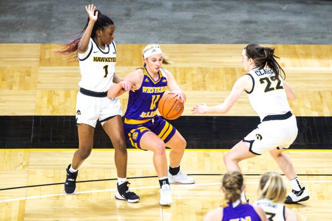 Iowa guard Tomi Taiwo (1) and Iowa guard Caitlin Clark (22) defends Western Illinois guard Mallory McDermott (11) during a NCAA non-conference women's basketball game, Tuesday, Dec. 22, 2020, at Carver-Hawkeye Arena in Iowa City, Iowa.