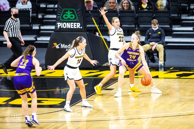 Western Illinois forward Kennedy Flanagan (24) drives to the basket as Iowa guard Caitlin Clark (22) defends during a NCAA non-conference women's basketball game, Tuesday, Dec. 22, 2020, at Carver-Hawkeye Arena in Iowa City, Iowa.