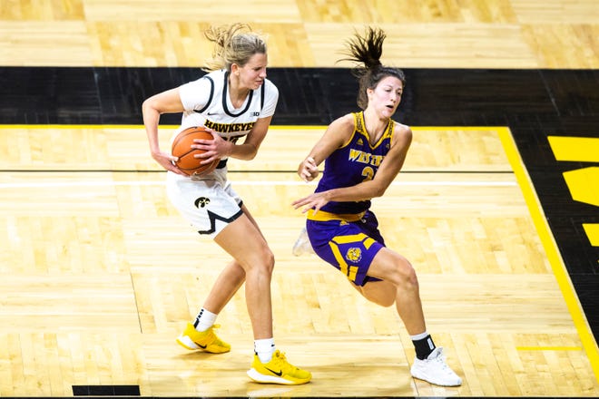 Iowa forward Logan Cook (23) pulls down a rebound against Western Illinois' Grace Gilmore during a NCAA non-conference women's basketball game, Tuesday, Dec. 22, 2020, at Carver-Hawkeye Arena in Iowa City, Iowa.