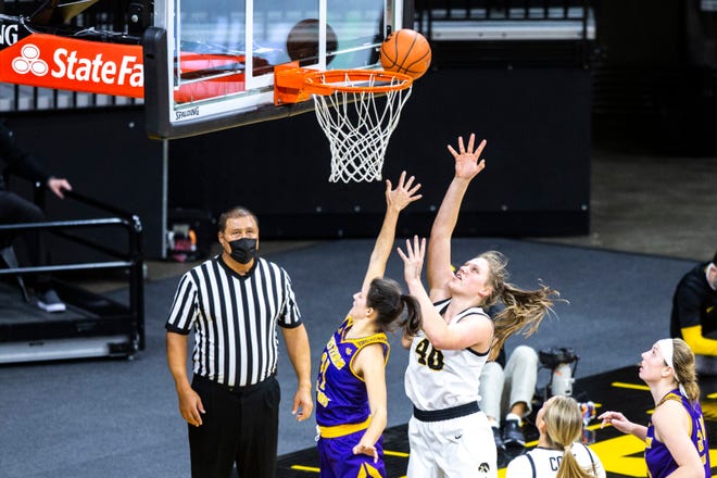 Iowa center Sharon Goodman (40) makes a basket as Western Illinois guard Grace Gilmore (21) defends during a NCAA non-conference women's basketball game, Tuesday, Dec. 22, 2020, at Carver-Hawkeye Arena in Iowa City, Iowa.