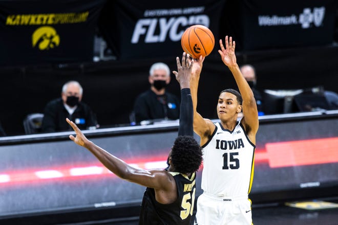 Iowa forward Keegan Murray (15) makes a 3-point basket as Purdue forward Trevion Williams (50) defends during a NCAA Big Ten Conference men's basketball game, Tuesday, Dec. 22, 2020, at Carver-Hawkeye Arena in Iowa City, Iowa.