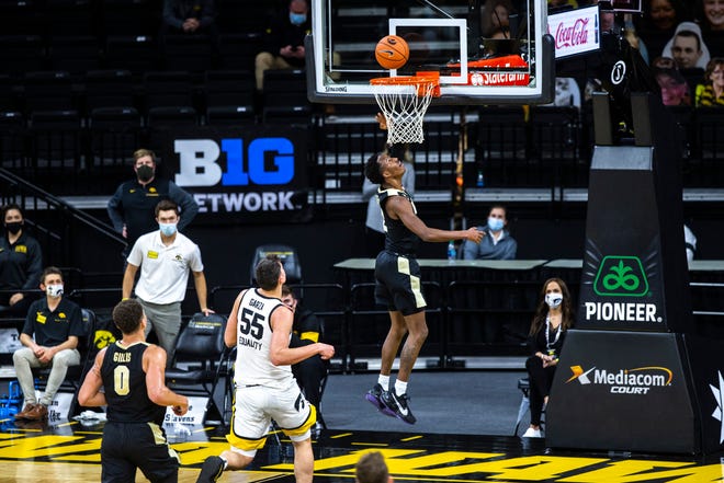 Purdue guard Eric Hunter Jr. (2) makes a basket as Iowa center Luka Garza (55) defends during a NCAA Big Ten Conference men's basketball game, Tuesday, Dec. 22, 2020, at Carver-Hawkeye Arena in Iowa City, Iowa.
