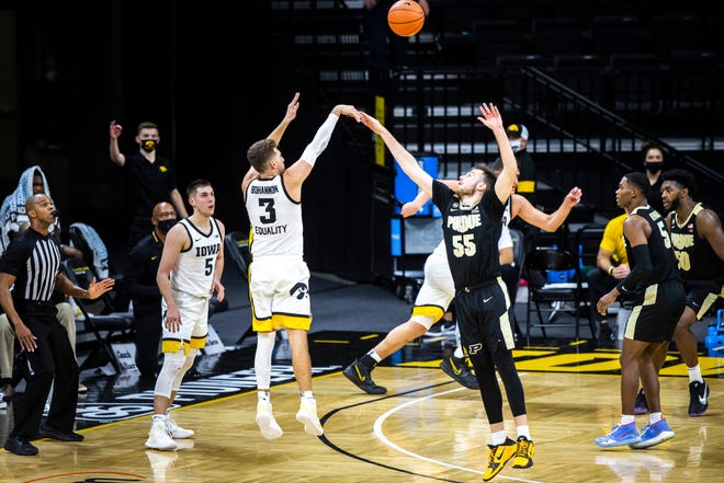 Iowa guard Jordan Bohannon (3) makes a 3-point basket as Purdue guard Sasha Stefanovic (55) defends during a NCAA Big Ten Conference men's basketball game, Tuesday, Dec. 22, 2020, at Carver-Hawkeye Arena in Iowa City, Iowa.