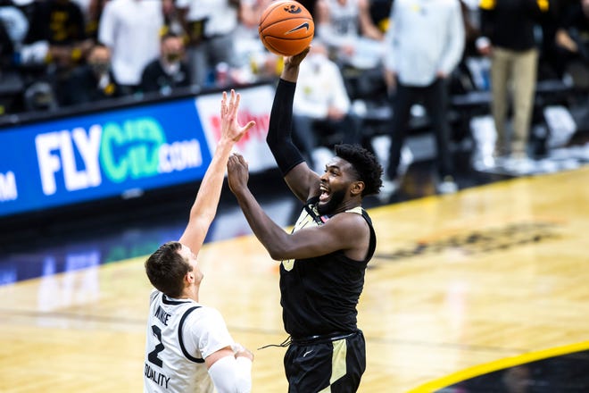 Purdue forward Trevion Williams (50) makes a basket as Iowa forward Jack Nunge (2) defends during a NCAA Big Ten Conference men's basketball game, Tuesday, Dec. 22, 2020, at Carver-Hawkeye Arena in Iowa City, Iowa.