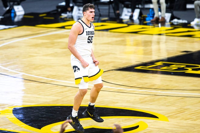 Iowa center Luka Garza (55) reacts after making a 3-point basket during a NCAA Big Ten Conference men's basketball game, Tuesday, Dec. 22, 2020, at Carver-Hawkeye Arena in Iowa City, Iowa.