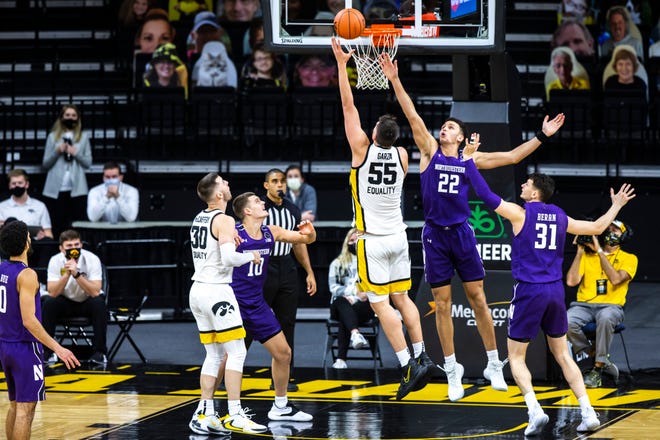 Iowa center Luka Garza (55) makes a basket as Northwestern forward Pete Nance (22) defends during a NCAA Big Ten Conference men's basketball game, Tuesday, Dec. 29, 2020, at Carver-Hawkeye Arena in Iowa City, Iowa.