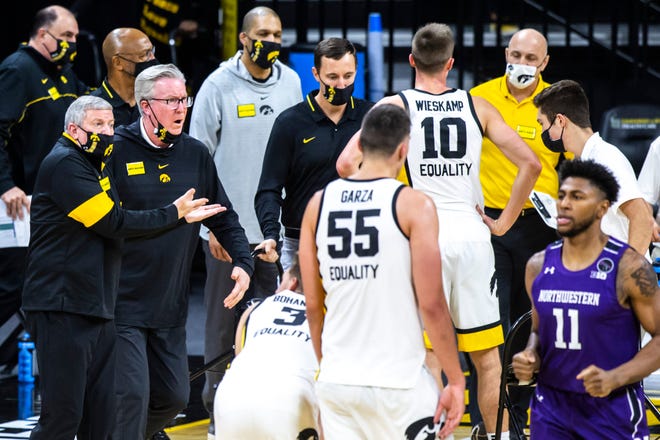 Iowa head coach Fran McCaffery, second from left, reacts to a call with Iowa assistant coach Kirk Speraw during a NCAA Big Ten Conference men's basketball game against Northwestern, Tuesday, Dec. 29, 2020, at Carver-Hawkeye Arena in Iowa City, Iowa.