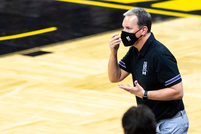Northwestern head coach Chris Collins calls out to players from the baseline while wearing a face mask during a NCAA Big Ten Conference men's basketball game, Tuesday, Dec. 29, 2020, at Carver-Hawkeye Arena in Iowa City, Iowa.