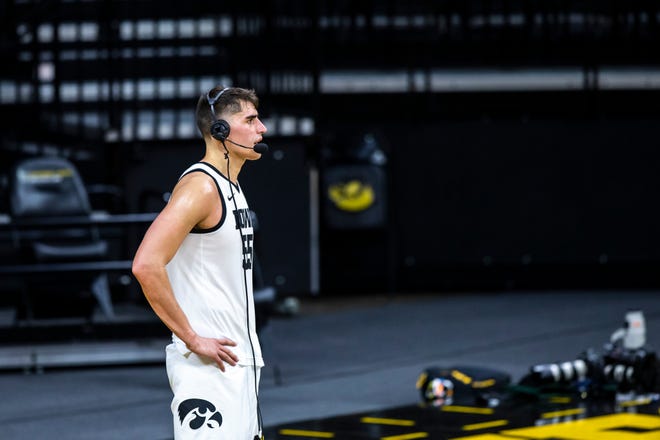 Iowa center Luka Garza (55) wears a headset while doing a post game interview after a NCAA Big Ten Conference men's basketball game against Northwestern, Tuesday, Dec. 29, 2020, at Carver-Hawkeye Arena in Iowa City, Iowa.