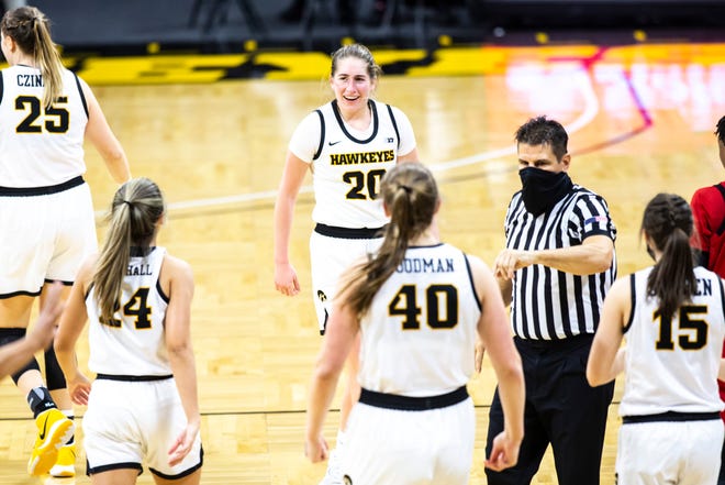 Iowa guard Kate Martin (20) celebrates with teammates heading into a timeout during a NCAA Big Ten Conference women's basketball game, Thursday, Dec. 31, 2020, at Carver-Hawkeye Arena in Iowa City, Iowa.