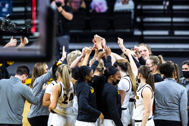 Iowa Hawkeyes players huddle up after a NCAA Big Ten Conference women's basketball game against Rutgers, Thursday, Dec. 31, 2020, at Carver-Hawkeye Arena in Iowa City, Iowa.