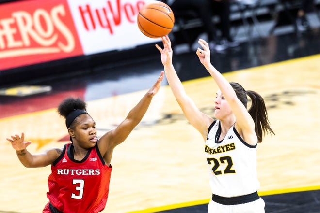 Iowa guard Caitlin Clark (22) makes a 3-point basket as Rutgers guard Diamond Johnson (3) ddefends during a NCAA Big Ten Conference women's basketball game, Thursday, Dec. 31, 2020, at Carver-Hawkeye Arena in Iowa City, Iowa.