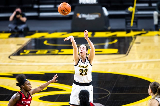 Iowa guard Caitlin Clark (22) makes a basket as Rutgers guard Diamond Johnson, left, defends during a NCAA Big Ten Conference women's basketball game, Thursday, Dec. 31, 2020, at Carver-Hawkeye Arena in Iowa City, Iowa.