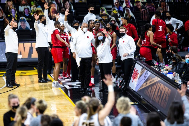 Rutgers head coach C. Vivian Stringer and Rutgers associate head coach Tim Eatman along with players wave from their bench after a NCAA Big Ten Conference women's basketball game against Iowa, Thursday, Dec. 31, 2020, at Carver-Hawkeye Arena in Iowa City, Iowa.