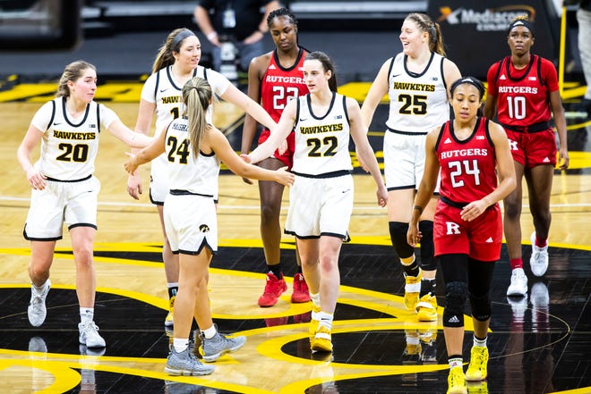 Iowa Hawkeyes players, from left, Kate Martin (20 McKenna Warnock Gabbie Marshall (24) Caitlin Clark (22) and Monika Czinano (25) walk up court during a NCAA Big Ten Conference women's basketball game against Rutgers, Thursday, Dec. 31, 2020, at Carver-Hawkeye Arena in Iowa City, Iowa.