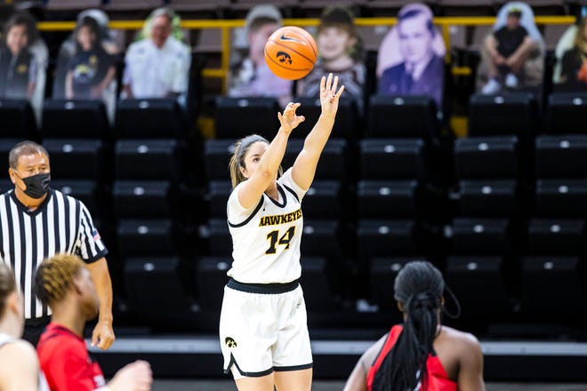 Iowa's McKenna Warnock (14) makes a 3-point basket during a NCAA Big Ten Conference women's basketball game against Rutgers, Thursday, Dec. 31, 2020, at Carver-Hawkeye Arena in Iowa City, Iowa.
