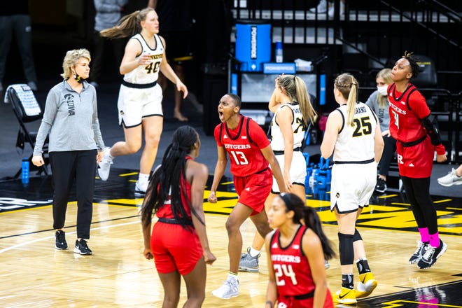 Rutgers forward Mael Gilles (13) reacts after making a basket before a Iowa head coach Lisa Bluder, left, called a timeout during a NCAA Big Ten Conference women's basketball game, Thursday, Dec. 31, 2020, at Carver-Hawkeye Arena in Iowa City, Iowa.