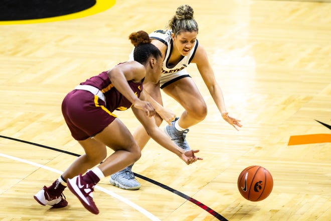 Iowa guard Alexis Sevillian, right, runs towards a loose ball against Minnesota guard Jasmine Powell during a NCAA Big Ten Conference women's basketball game, Wednesday, Jan. 6, 2021, at Carver-Hawkeye Arena in Iowa City, Iowa.