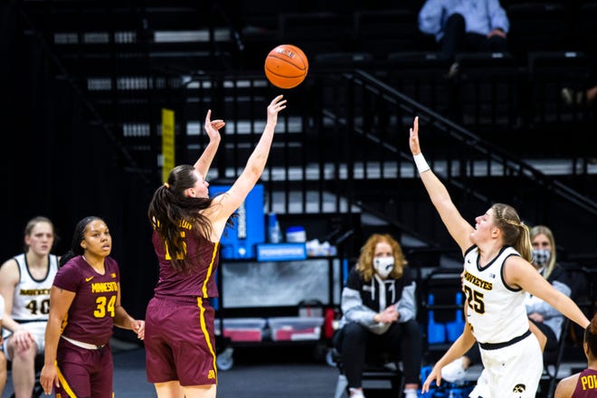 Minnesota forward Kayla Mershon (15) makes a 3-point basket as Iowa center Monika Czinano (25) defends during a NCAA Big Ten Conference women's basketball game, Wednesday, Jan. 6, 2021, at Carver-Hawkeye Arena in Iowa City, Iowa.