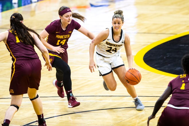 Iowa guard Gabbie Marshall (24) dribbles to the basket as Minnesota guard Sara Scalia (14) defends during a NCAA Big Ten Conference women's basketball game, Wednesday, Jan. 6, 2021, at Carver-Hawkeye Arena in Iowa City, Iowa.