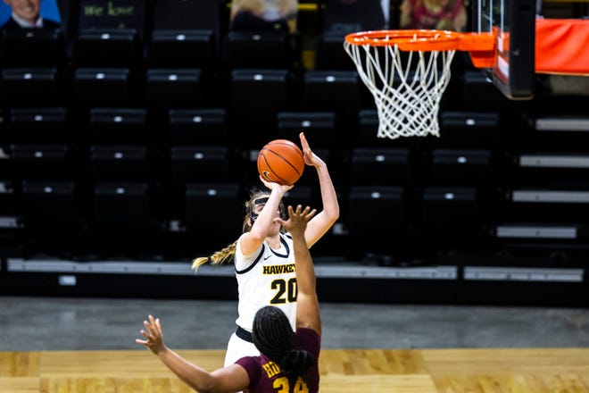 Iowa guard Kate Martin (20) makes a 3-point basket as Minnesota guard Gadiva Hubbard (34) defends during a NCAA Big Ten Conference women's basketball game, Wednesday, Jan. 6, 2021, at Carver-Hawkeye Arena in Iowa City, Iowa.