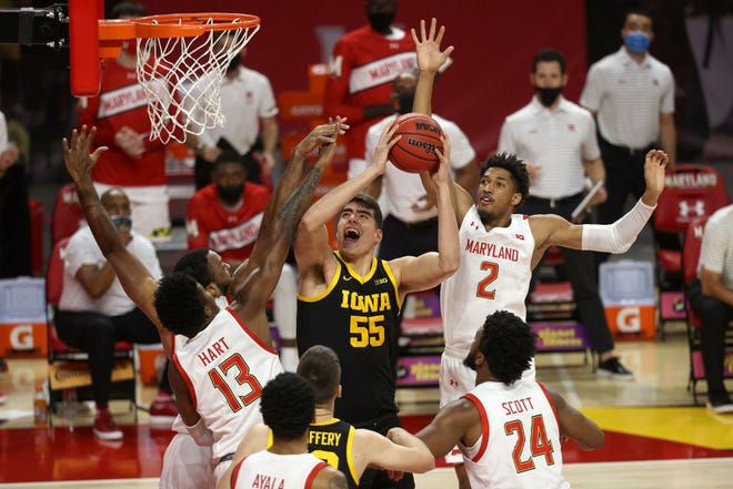 COLLEGE PARK, MARYLAND - JANUARY 07: Luka Garza #55 of the Iowa Hawkeyes puts up a shot in front of Hakim Hart #13 and Aaron Wiggins #2 of the Maryland Terrapins in the first half at Xfinity Center on January 07, 2021 in College Park, Maryland.