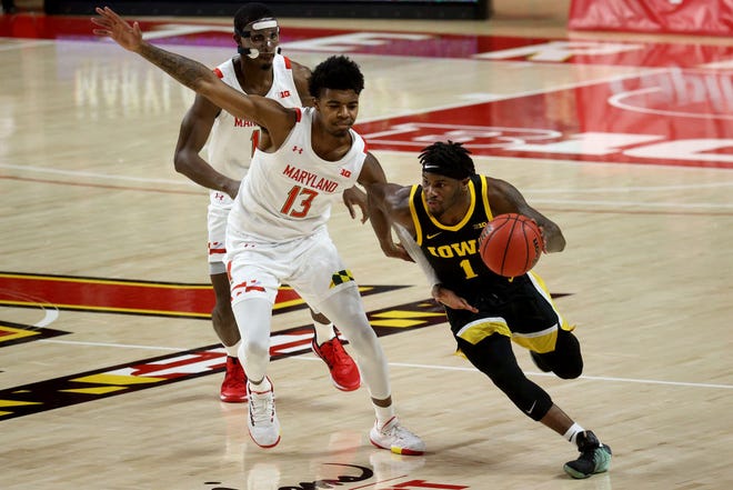 COLLEGE PARK, MARYLAND - JANUARY 07: Joe Toussaint #1 of the Iowa Hawkeyes dribbles around Hakim Hart #13 of the Maryland Terrapins in the first half at Xfinity Center on January 07, 2021 in College Park, Maryland.