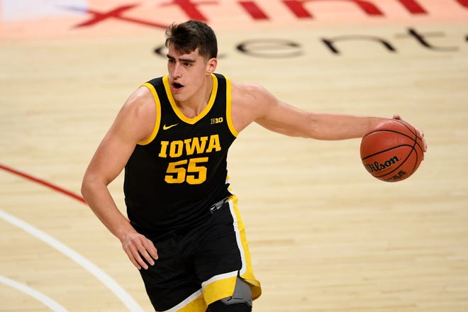Iowa center Luka Garza (55) dribbles during the first half of an NCAA college basketball game against Maryland on Jan. 7 in College Park, Maryland.