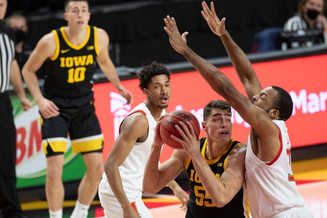 Jan 7, 2021; College Park, Maryland, USA;  Iowa Hawkeyes center Luka Garza (55) makes a move to the basket as Maryland Terrapins forward Galin Smith (30) defends during the first half at Xfinity Center.